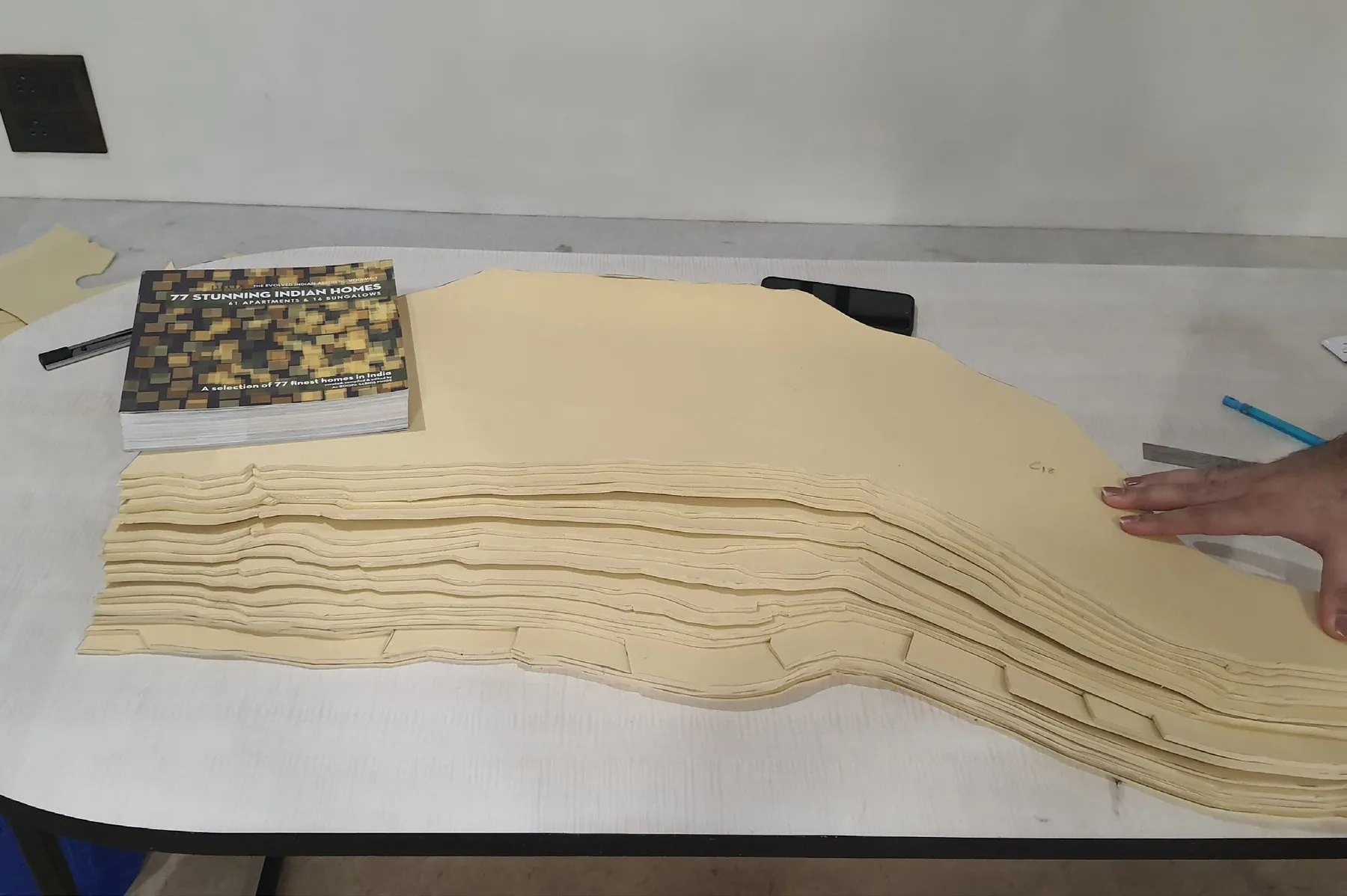 Stacked card contours of the site model on a workbench before painting