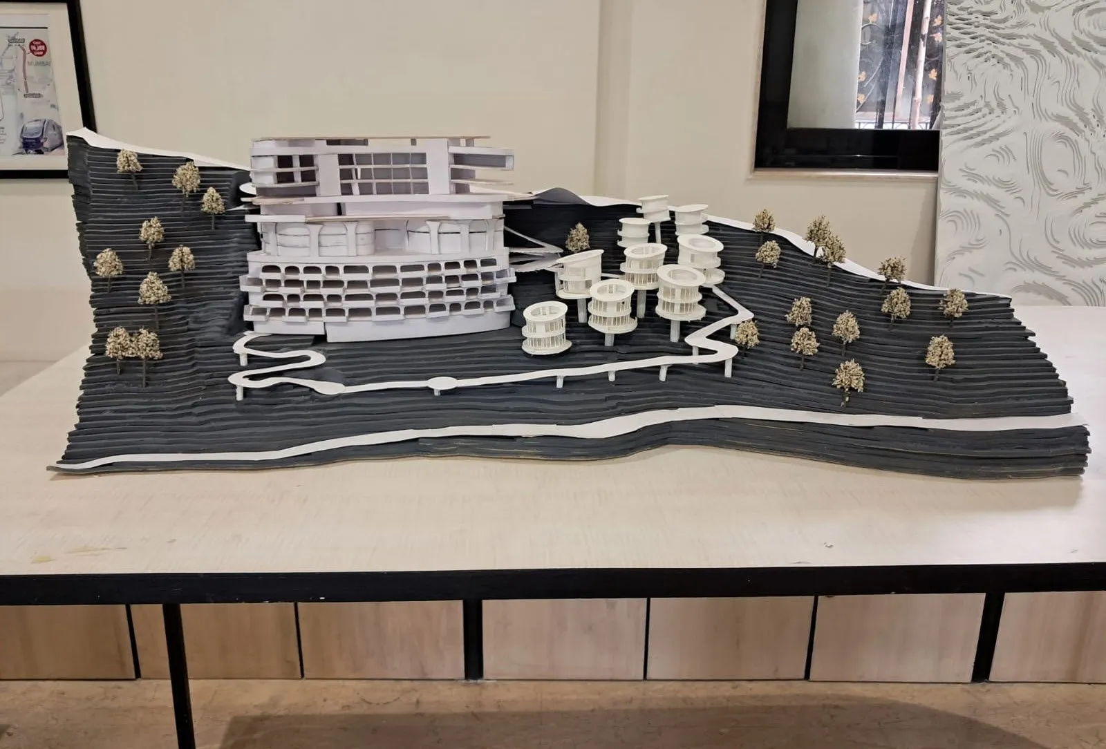 The finished dark site model with the hotel, cottage pods, roads and trees